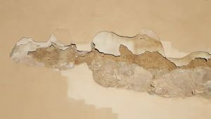 Fragment nowoczesnej łazienki z drewnianą ścianą i umywalką, podkreślający naturalne materiały i minimalistyczny design.